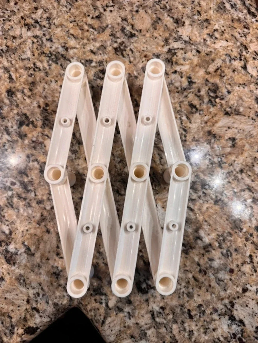 Vintage white plastic 10 peg accordion rack